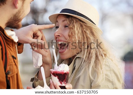 Couple tourist walking in downtown and eating ice-cream.