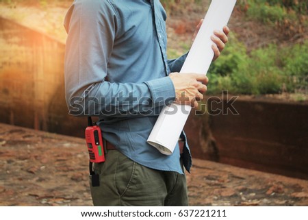 The blue-collar engineer holds the paper roll, the plant is done.