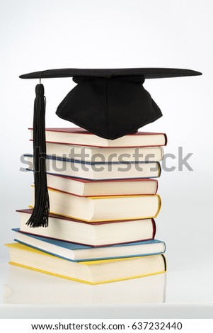 mortarboard on books stack
