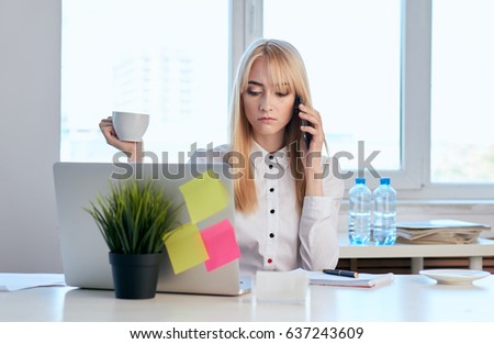  Business blonde behind the Desk with laptop talking on the phone,the stickers pasted                              