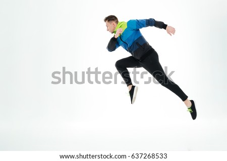 Picture of serious strong sportsman running isolated over white background. Looking aside.