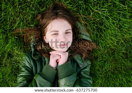 Beautiful free teen relaxing on the grass summer	