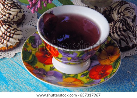 hot tea and biscuits. A bouquet of lilacs. Blue background