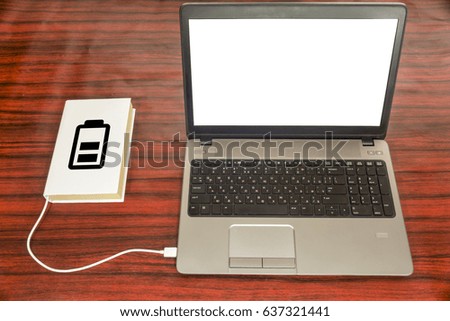 Book connected to a laptop through a USB charger. Battery symbol indicating the charge level.