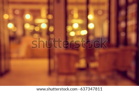 Abstract blur image of  Cafe or restaurant  in night time with bokeh for background usage . (vintage tone)