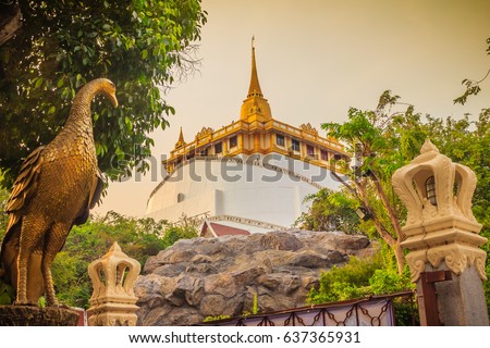 Beautiful peacock sculpture at front of Wat Saket Ratcha Wora Maha Wihan (Wat Phu Khao Thong, Golden Mount temple), a popular Bangkok tourist attraction and has become one of the symbols of the city. Royalty-Free Stock Photo #637365931