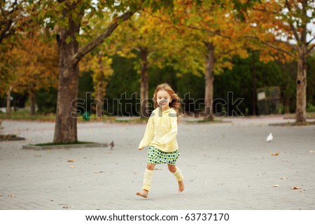 Cute child walking in autumn park