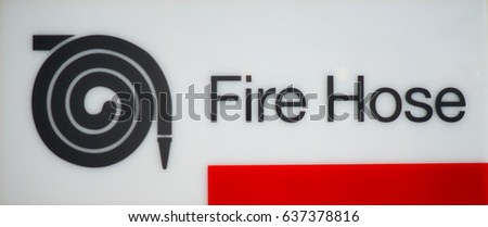 fire hose sign consisting of picture of fire hose and word with red line