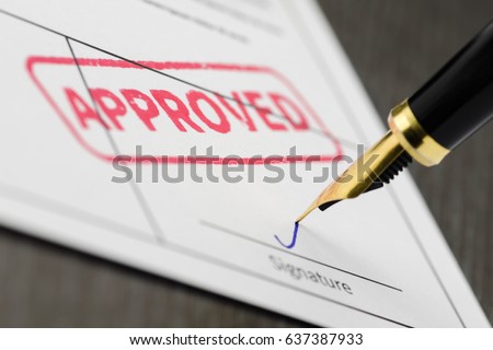 Form close up, fountain pen and approved stamped on a document. Soft focus. Royalty-Free Stock Photo #637387933