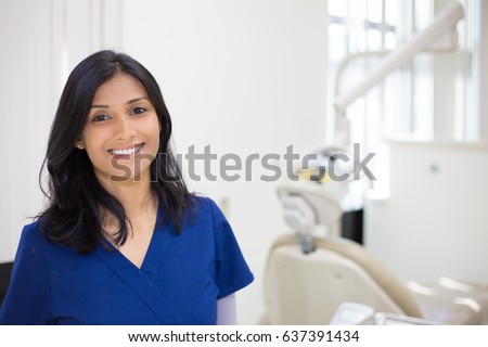 Closeup headshot portrait of friendly, cheerful, smiling confident female, healthcare professional in blue scrubs. isolated clinic hospital background. Patient visit. Royalty-Free Stock Photo #637391434
