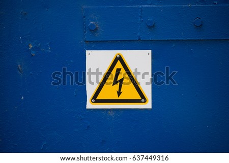 High voltage sign on blue metal door