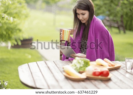 Woman checking social media on smart phone at morning breakfast