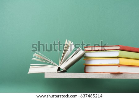 Open book, hardback books on wooden table. Education background. Back to school. Copy space for text