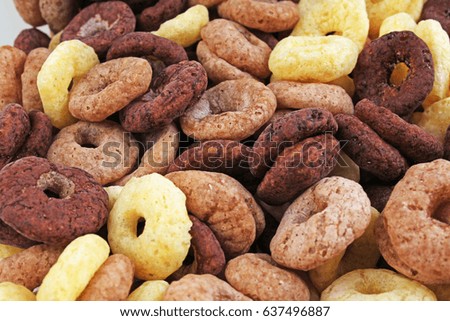 Breakfast cereals as background. Chocolate vanilla and caramel cinnamon flavored cereal muesli