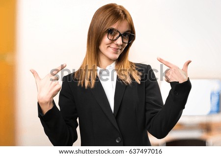 Young business woman proud of herself on unfocused background