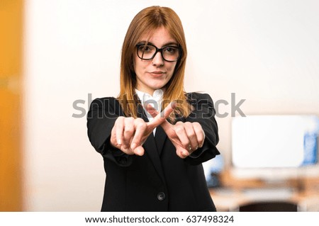 Young business woman making NO gesture on unfocused background