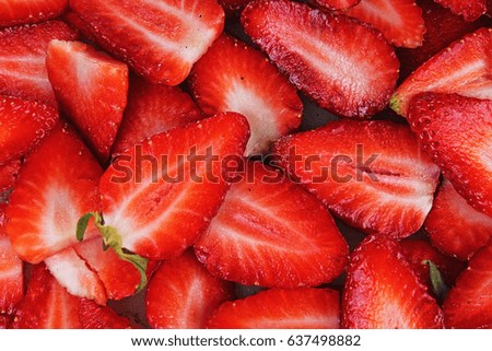 Red fruits. Half strawberries as background. Strawberry pattern.