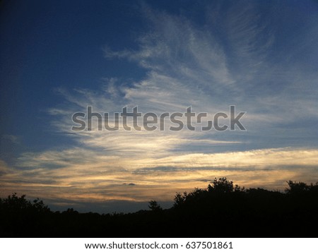 dark blue sky with many golden and orange clouds