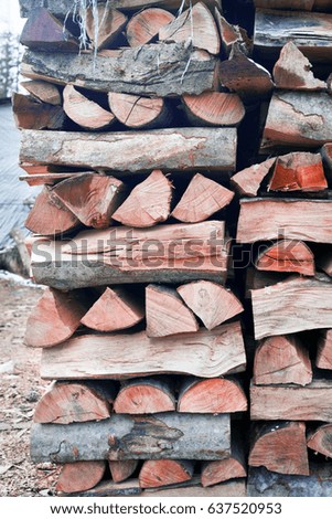 Warehouse a stack of cut chopped sawn natural firewood in a mountain resort A good ecological and economic option for heating houses and hotels in winter and summer