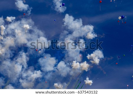 Colorful balloons in the air during an amazing firework