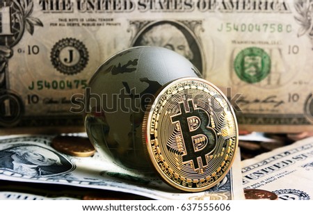 bitcoin coin and cristal globe over  one dollar banknote 