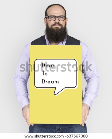 People holding a board about dare to dream quotation