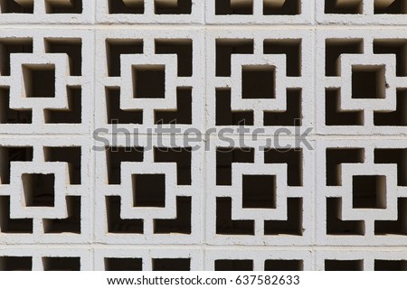 Square, geometric architectural concrete cinder blocks "breeze blocks" with neat unique design, allow air to flow freely through them Royalty-Free Stock Photo #637582633