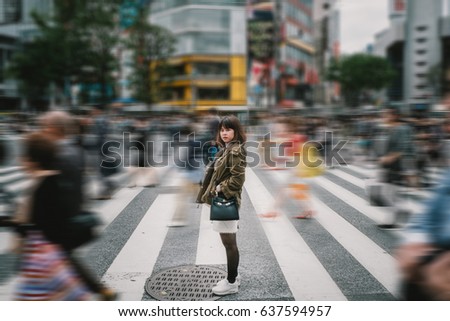Portrait girl crossing busy city street/ Girl Crossing Street/ Girl crossing street in Tokyo, Japan