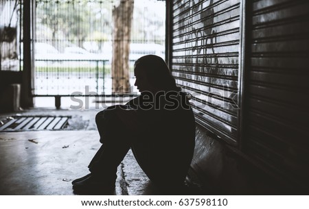 Homeless Woman Sitting on The Street Side Hopeless Royalty-Free Stock Photo #637598110
