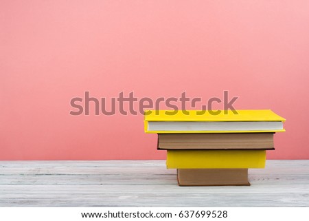 Book stacking. Open book, hardback books on wooden table and blue background. Back to school. Copy space for text