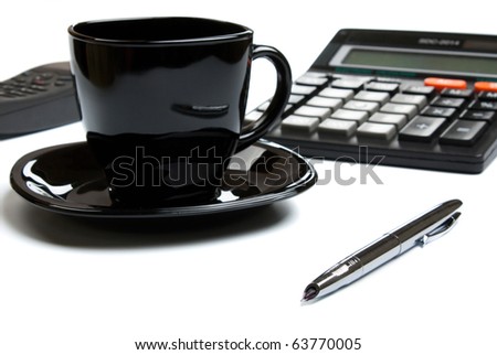 coffee mug, calculator, pens, phone on white table