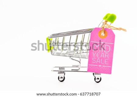 Blank pink paper price tag with shopping cart isolated on white background