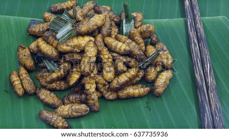 Fried insects on banana leaf.