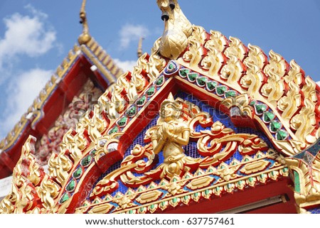 The angel pattern adorned at the gable of the temple  with blue sky. Thailand.                