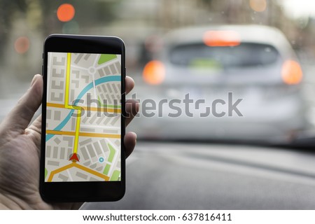 GPS Navigation on Mobile Phone Device and Transportation Concept. Male Hand Using Navigation System Map Tracking on Smartphone with Copy Space. Royalty-Free Stock Photo #637816411