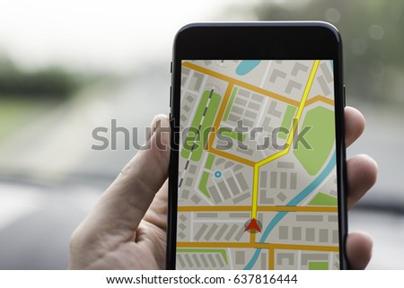 GPS Navigation on Mobile Phone Device and Transportation Concept. Male Hand Using Navigation System Map Tracking on Smartphone with Copy Space. Royalty-Free Stock Photo #637816444