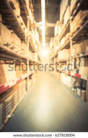 Blur large furniture warehouse in America, row aisles, bins, shelves from floor to ceiling. Defocused industrial storehouse interior full of boxes. Inventory, wholesale, logistic, export. Vintage tone