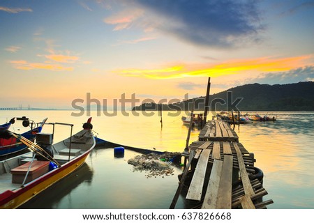 Sunrise in Pantai Jerjak under Penang Bridge Malaysia with some siloute people, Hammer bay at jetty 