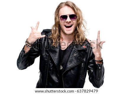 portrait of handsome rocker in black leather jacket and sunglasses showing rock signs isolated on white, rock star concept Royalty-Free Stock Photo #637829479