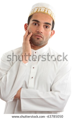 A man wearing cultural ethnic robe and decorative topi thinking.  White background. Royalty-Free Stock Photo #63785050
