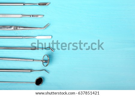 Set of dentist tools on wooden background Royalty-Free Stock Photo #637851421