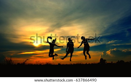 Silhouette of a children jumping on sky light of the sunset, look like they can flying.