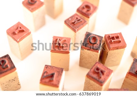 Rubber and wood letter molds on white background