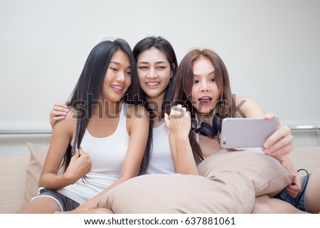 Close up portrait of beautiful asian woman use smartphone for selfie with attractive smiling together, 20-30 year old.