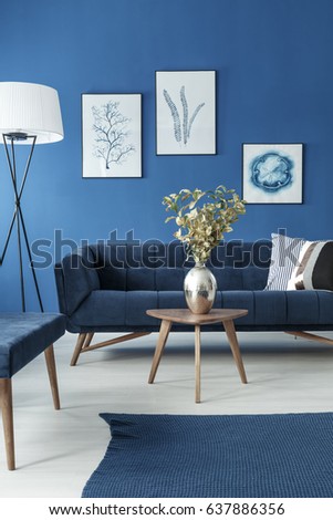 Blue and white living room with sofa and small wooden coffee table
