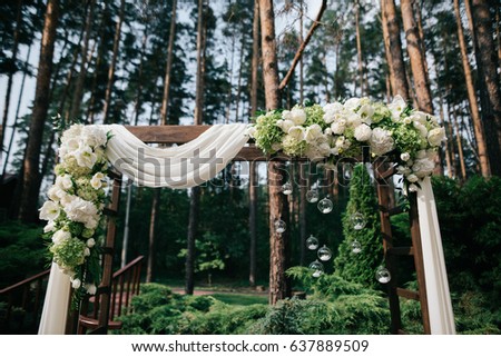 Wedding altar decorated with white flowers and cloth