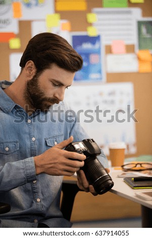 Close up of professional photographer using camera in creative office