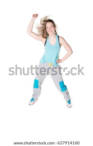 Young, pretty natural looking girl in sport t -shirt and jogging pants having fun dancing. Full body studio shot, pure white background. 
