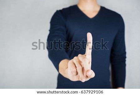 Man index finger gesture, wearing long-sleeved shirt, no face on grey background Royalty-Free Stock Photo #637929106