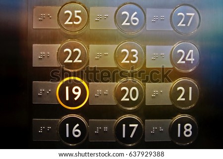 Elevator or lift numeric indicator at 19th floor with low light supply illustrated numbers and Braille signs language